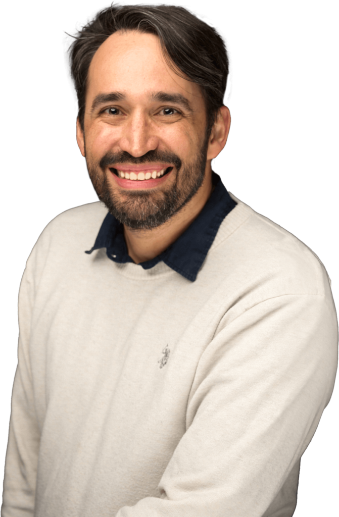 Photo of Ronald Smiling wearing a white sweater